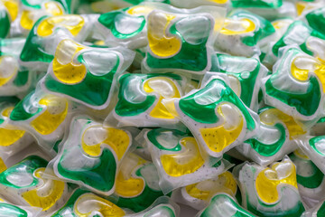 Dishwasher detergent capsules and or laundry soap close-up background.
