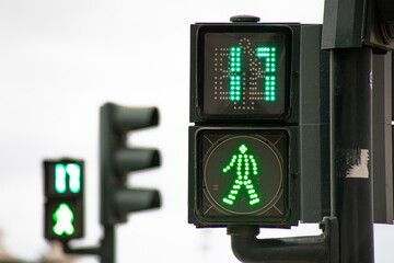 Green traffic light for pedestrians counting down in 17 seconds in Lisbon