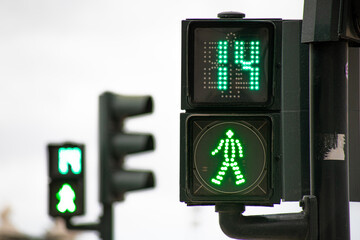 Green traffic light for pedestrians counting down in 14 seconds in Lisbon