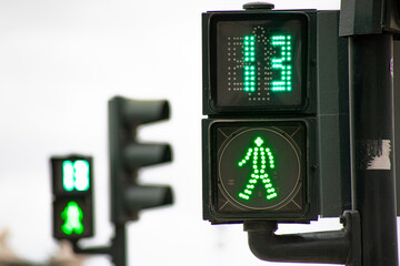 Green traffic light for pedestrians counting down in 13 seconds in Lisbon