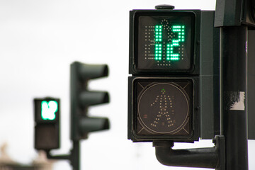Green traffic light for pedestrians counting down in 12 seconds in Lisbon