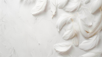 Fototapeta premium Scattered white feathers on a white surface. Top view. Copy space.