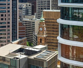 Sydney, Australia - The historic clock tower of the Department of Lands Building in the city of Sydney surrounded by modern skyscrapers.