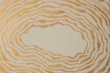 Gold bronze glitter ink watercolor wave line strip stain blot on beige grain paper texture background.