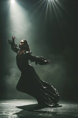 A woman in a black dress is energetically dancing on a stage, showcasing flamenco moves in a dramatic pose