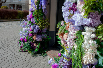Decorating the facade with flowers. Spring floral decorations.