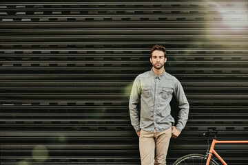 Portrait, man and fashion with clothes by wall for design of creative business worker by lens...