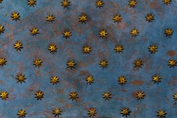 Golden stars on an old cathedral blue ceiling