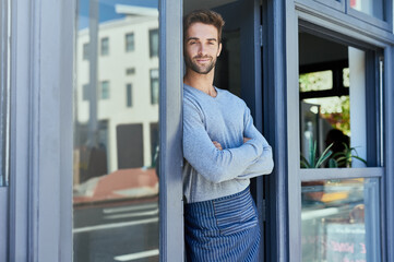 Door, crossed arms and portrait of barista by coffee shop with positive, happy and confident...