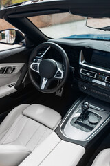Modern expensive convertible car interior with leather panel, sport seats, multimedia and digital dashboard