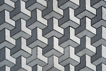 Architecture on street paved with slabs. Sidewalk with gray and white paving stones, cement rectangular tiles. paints of floor in modern city background.