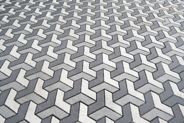 Architecture on street paved with slabs. Sidewalk with gray and white paving stones, cement rectangular tiles. paints of floor in modern city background.