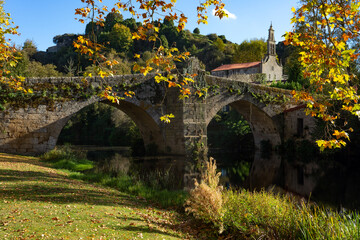 Romanesque stone bridge and Santa María de Vilanova church in the beautiful village of Allariz in...
