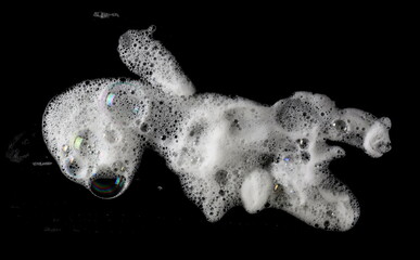 Soap foam, bubbles isolated on black, with clipping path, top view