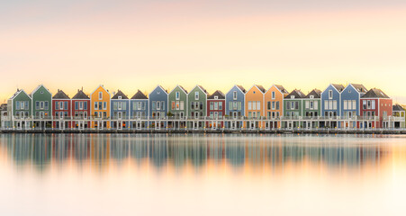 Colorful buildings by water at dusk, creating a picturesque cityscape