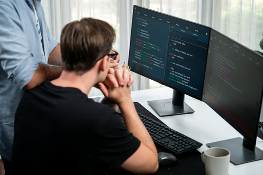 IT developers discussing online software development information on pc screen, creating program coding for latest version application on website. Concept of brainstorming firmware updated. Sellable.