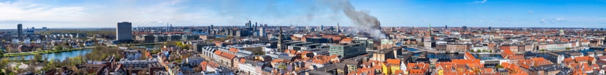 Black smoke drifts over central Copenhagen as historic Copenhagen stock exchange in Denmark goes up...