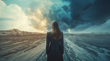 A woman stands in the middle of a desolate landscape, looking out at the horizon. The sky is dark...