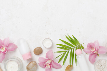 Composition with orchids, spa products on concrete background, top view