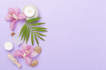 Composition with orchids, spa products on color background, top view