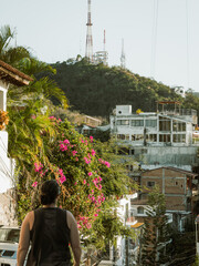 Low angle view hill of the Cross Viewpoint in Puerto Vallarta, Mexico with woman walking in foreground.