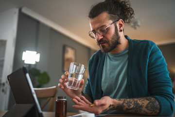 One adult man drink medicine drug tablet or supplement vitamin at home