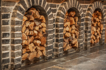 Stacked Firewood in Brick Alcoves for Rustic Decor