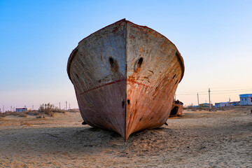 Rusty shipwreck lying on the seabed of the dried-up Aral Sea in Moynaq (or Muynak), a former...
