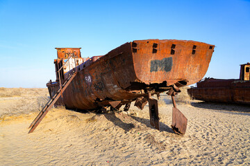 Naklejka premium Rusty shipwreck lying on the seabed of the dried-up Aral Sea in Moynaq (or Muynak), a former fishing town in Karakalpakstan, Uzbekistan