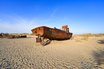 Rusty shipwreck lying on the seabed of the dried-up Aral Sea in Moynaq (or Muynak), a former...