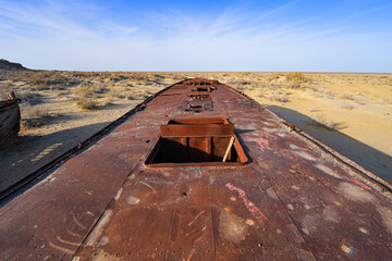 Rusty shipwreck lying on the seabed of the dried-up Aral Sea in Moynaq (or Muynak), a former...