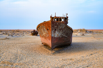Rusty shipwreck lying on the seabed of the dried-up Aral Sea in Moynaq (or Muynak), a former...
