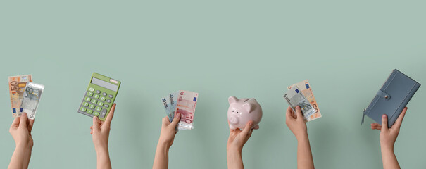Women with euro banknotes, piggy bank and wallet on green background