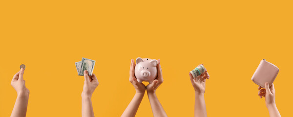 Women with money, piggy bank and wallet on yellow background