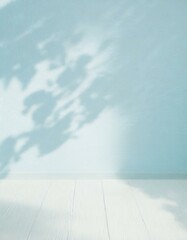 Bright light pastel pale delicate blue room wall flatlay as background. Abstract natural floral shadow patterns. White wooden floor.