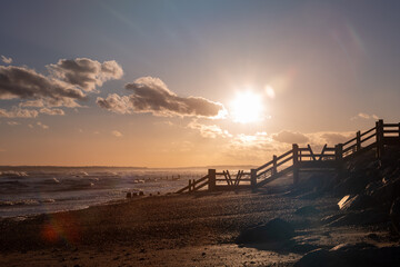 Evening sunset over Camber sands in East Sussex, Image shows a the end of a beautiful golden orange...