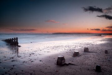 Long exposure landscape photograph at Camber sands beach on a warm evening, Image shows the...