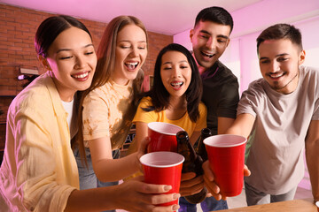 Group of young friends drinking beer at party