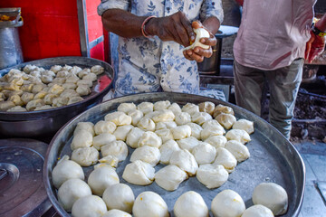Seller preparing Traditional Cardamom Kachori, street food in markets and bazaar