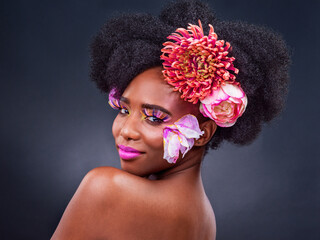 Beauty, makeup and flowers with portrait of black woman in studio on dark background for natural...