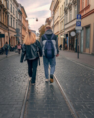 An urban adventure for Gen Z couples in the evening in a historic European city, showcasing travel,...