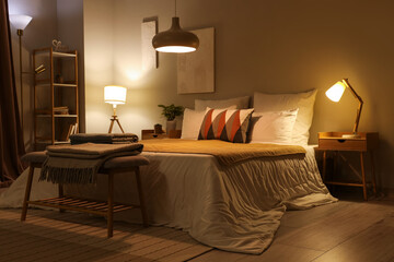 Interior of stylish cozy bedroom in evening - obrazy, fototapety, plakaty