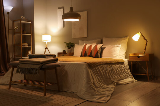 Naklejki Interior of stylish cozy bedroom in evening