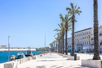 Lungomare in Brindisi, a pedestrian walkway next to the beach and surrounding old town. Row of...