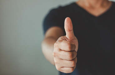 Midsection of happy businessman showing thumbs up gesture sign in white background with copy space. Recommend, confident, like, ok, yes, positive, approval, accept, good, satisfaction, achievement.