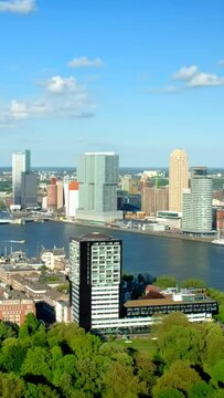 View of Rotterdam city and the Erasmus bridge Erasmusbrug over Nieuwe Maas river from Euromast. With camera panning