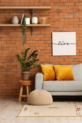 Loft style living room with grey sofa and houseplant