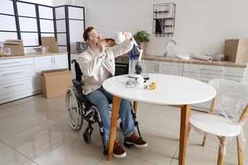 Young man in wheelchair repairing lamp at home