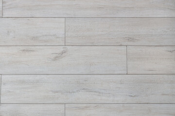 Light wooden laminate floor as background, closeup