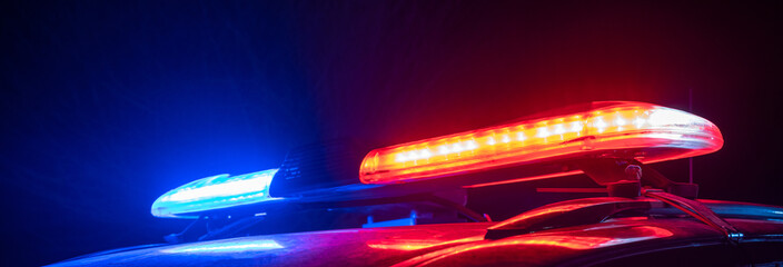 Red and blue lights of a police car at night, stock photo